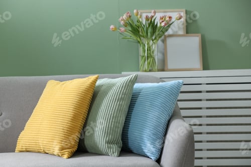 Preview: Stylish sofa with colorful cushions in room, closeup