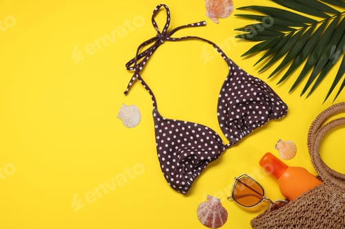 Preview: Flat lay composition with beach accessories on yellow background. Space for text