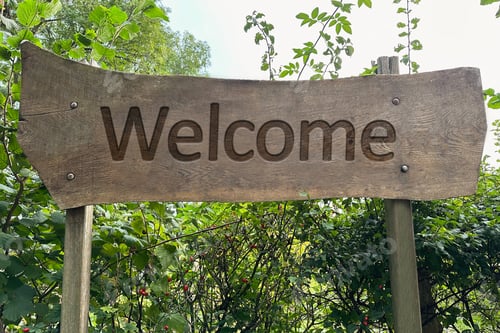 Preview: Welcome wooden sign board and different plants outdoors