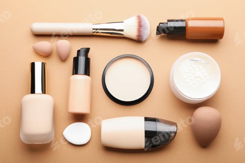 Preview: Face powders, foundation, brush and sponges on beige background, flat lay