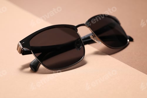 Preview: Pair of stylish sunglasses on color background, closeup