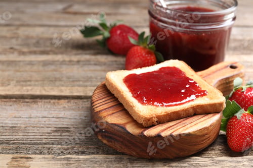 Preview: Toasted bread with strawberry jam and fresh berries on wooden table, closeup. Space for text