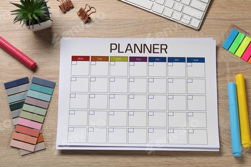 Preview: Planner and stationery on wooden desk, flat lay