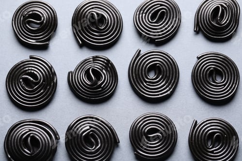 Preview: Natural licorice candies on gray background, flat lay