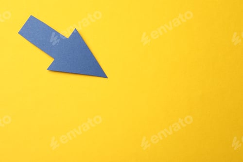 Preview: Blue paper arrow on yellow background, top view. Space for text