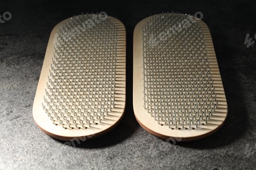 Preview: Nail standing practice. Sadhu boards on gray textured background, closeup