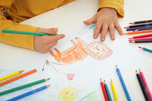 Preview: Little boy drawing lion with pencil at table, closeup