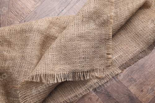 Preview: Natural burlap fabric on wooden table, top view