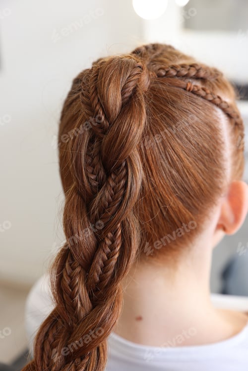 Preview: Teenage girl with beautiful braids in salon, back view