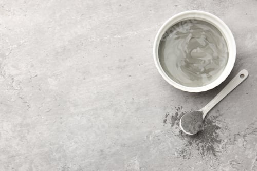 Preview: Mud therapy. Natural clay paste for facial and body care and powder on grey table, flat lay. Space f