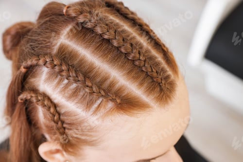 Preview: Teenage girl with beautiful braids in salon, closeup