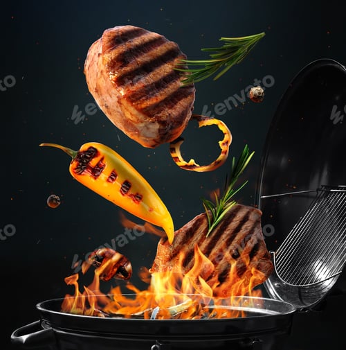 Preview: Meat, pepper and rosemary flying above barbecue grill against dark background