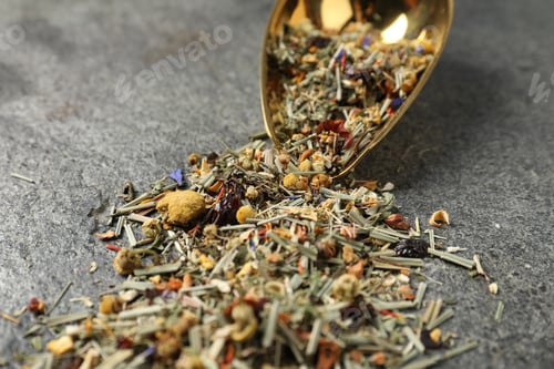 Preview: Dried green tea leaves and metal spatula on grey table, closeup