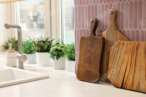 Preview: Many wooden cutting boards on countertop in kitchen