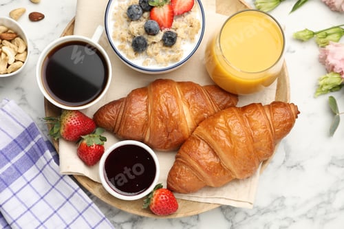 Preview: Healthy breakfast. Flat lay composition with tasty croissants and oatmeal with berries on white marb