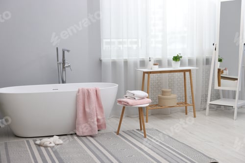 Preview: Stylish bathroom with bathtub, towels and mirror