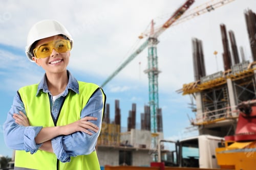 Preview: Builder or architect in workwear at construction site