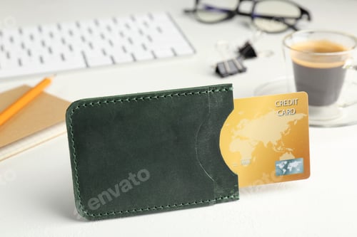 Preview: Leather card holder with credit card, stationery, coffee and keyboard on white table