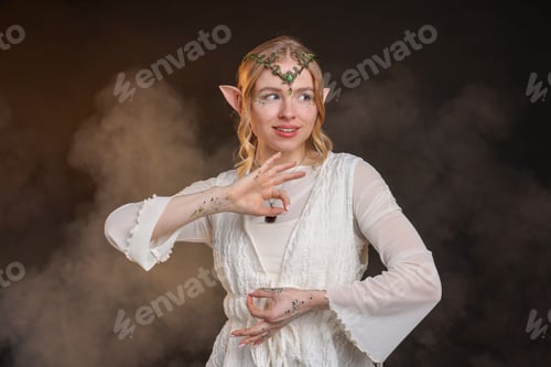 Preview: Beautiful girl dressed as elf on black background with smoke