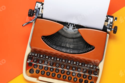 Preview: Vintage typewriter with paper on color background, top view