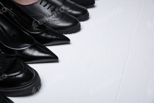 Preview: Different beautiful shoes on white wooden floor, closeup. Space for text