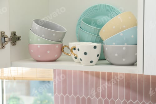 Preview: Cabinet with different clean dishware in kitchen, closeup