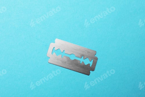 Preview: One sharp blade on light blue background, top view