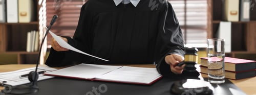 Preview: Judge working with document at desk indoors