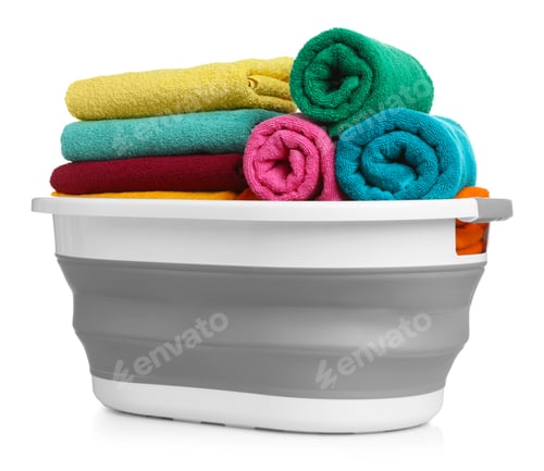Preview: Many soft clean towels in laundry basket isolated on white
