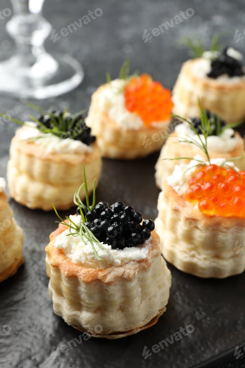Preview: Tasty puff pastries with cream cheese, caviar and dill on table, closeup