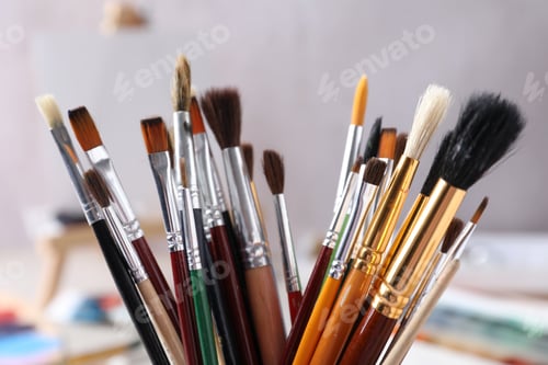 Preview: Different paint brushes on blurred background, closeup