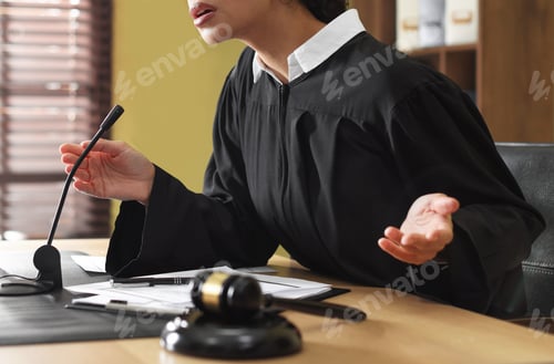 Preview: Judge working at wooden desk in courtroom