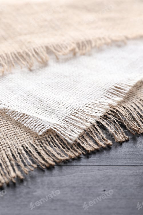 Preview: Natural burlap fabrics on wooden table, closeup