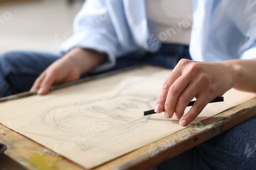 Preview: Woman drawing picture with charcoal in studio, closeup