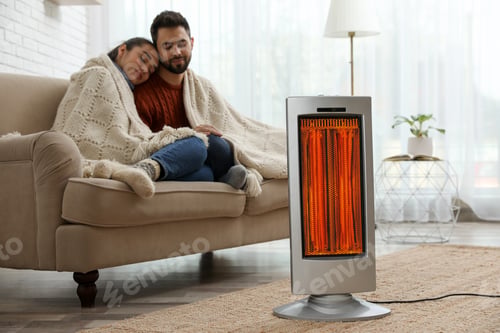 Preview: Couple on sofa in room with electric heater
