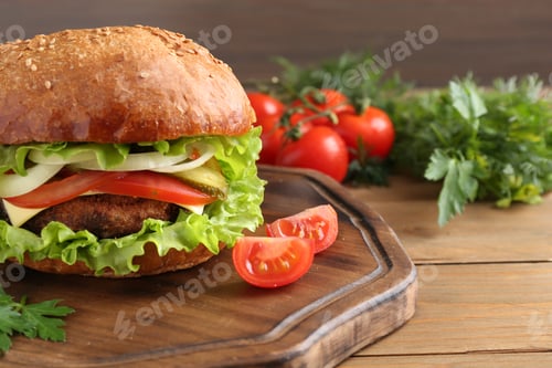 Preview: Delicious vegetarian burger served on wooden table, closeup