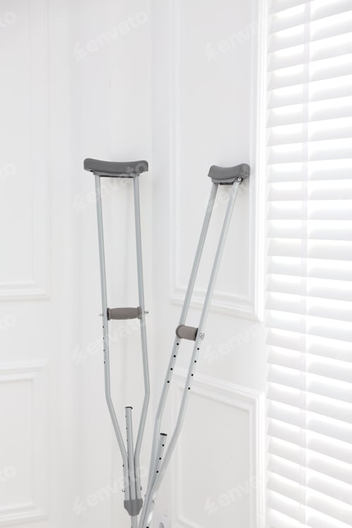 Preview: Metal axillary crutches near window indoors. Mobility aid