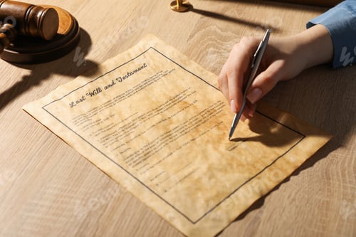 Preview: Woman signing Last Will and Testament at wooden table indoors, closeup