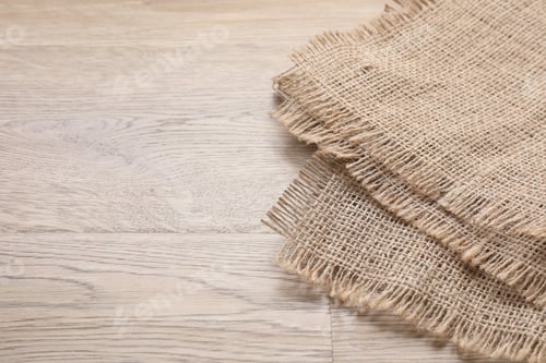 Preview: Natural burlap fabric on wooden table, closeup. Space for text