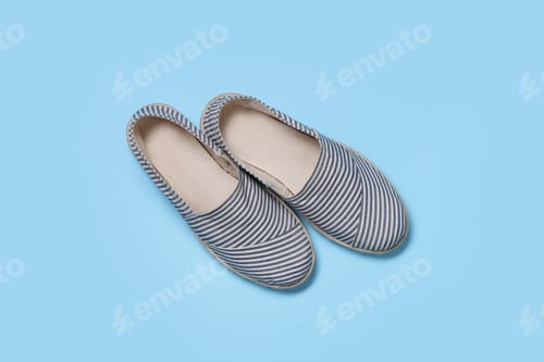 Preview: Pair of stylish espadrille shoes on light blue background, flat lay