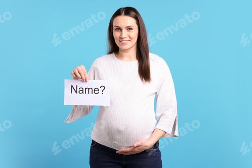 Preview: Pregnant woman holding card with word Name and question mark on light blue background
