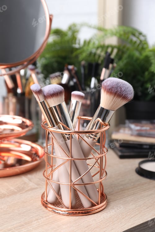 Preview: Makeup brushes in holder on wooden vanity indoors
