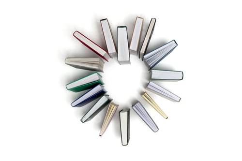 Preview: Books arranged in shape of heart isolated on white