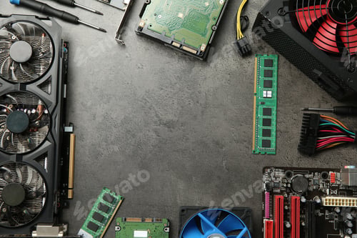 Preview: Frame of graphics card and other computer hardware on grey textured table, flat lay. Space for text
