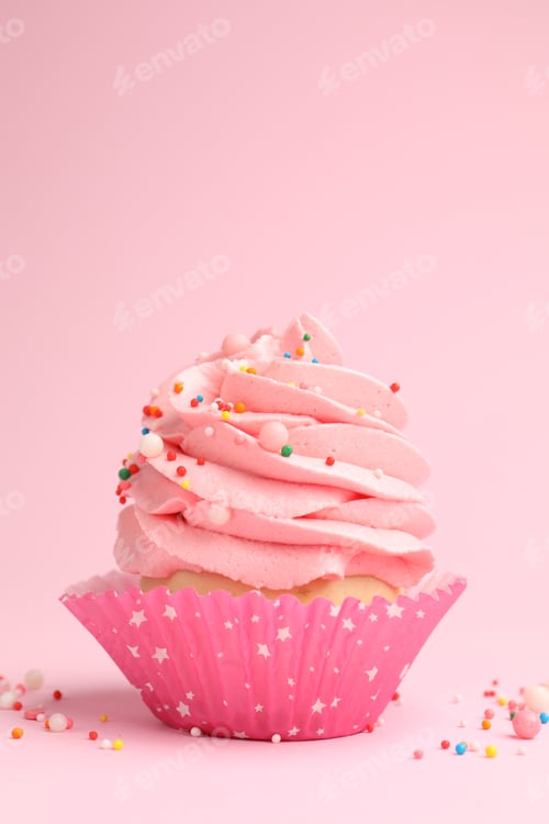 Preview: Yummy cupcake with sprinkles on pink background, closeup