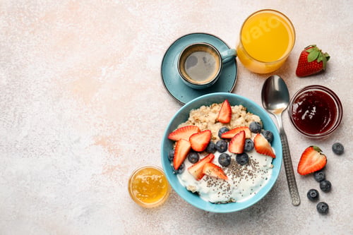 Vista previa: Tasty breakfast with oatmeal served on light table, flat lay. Space for text