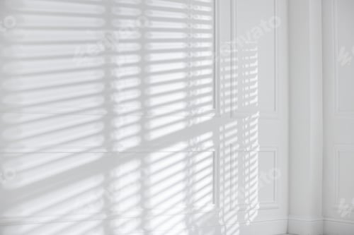 Preview: Light and shadows from window blinds falling on white wall
