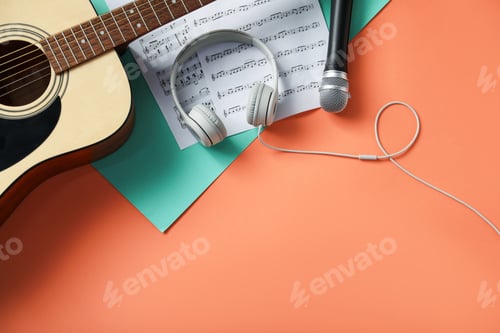 Preview: Headphones, microphone, music sheets and guitar on color background, flat lay. Space for text