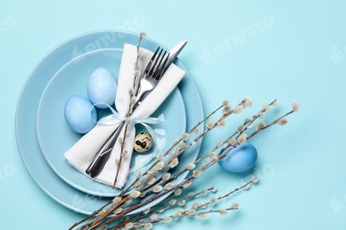 Preview: Easter celebration. Festive table setting with willow branches and painted eggs on light blue backgr