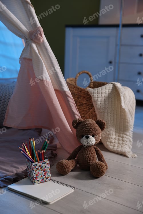 Preview: Beautiful wigwam, cushions and toys in child's room at night